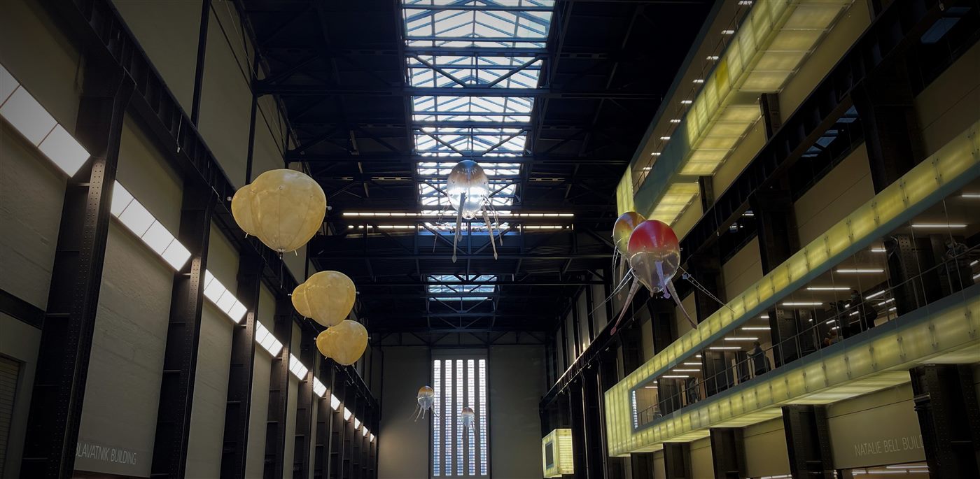 A fleet of aerobes flying at different heights across Tate Modern's Turbine Hall