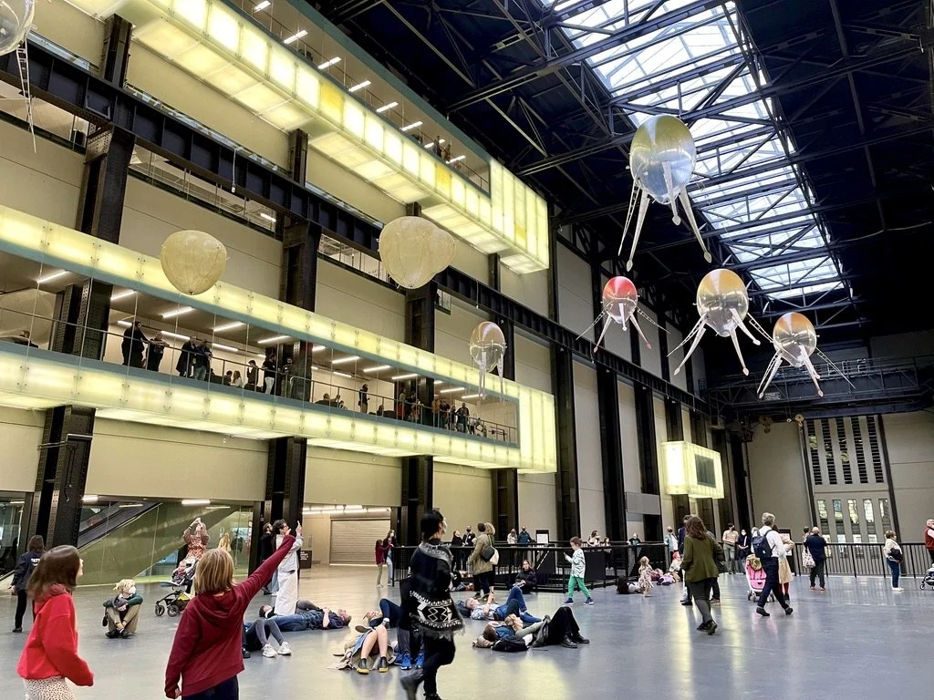Aerobes in flight above visitors in Tate Modern's Turbine Hall